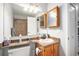 Bright bathroom with large mirror and neutral walls at 7468 S Alkire St # 205, Littleton, CO 80127