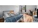 Bright bedroom with wood floors, ample natural light, and plenty of space at 7468 S Alkire St # 205, Littleton, CO 80127
