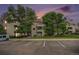 Multi-story apartment building with lush landscaping and ample parking at 7468 S Alkire St # 205, Littleton, CO 80127