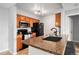 Kitchen with stone countertops, stainless microwave, and black appliances with view to dining area at 7468 S Alkire St # 205, Littleton, CO 80127