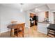 Eat-in kitchen features stainless steel appliances, breakfast bar, and adjoining dining area at 7468 S Alkire St # 205, Littleton, CO 80127