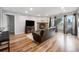 Open-plan living room featuring a fireplace, balcony access, and seamless flow at 7468 S Alkire St # 205, Littleton, CO 80127