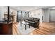 Inviting living room with stone fireplace, hardwood floors, and sliding glass doors to a balcony at 7468 S Alkire St # 205, Littleton, CO 80127