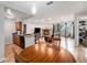 Open concept kitchen and living space featuring a stone fireplace and access to the balcony at 7468 S Alkire St # 205, Littleton, CO 80127