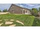 Large backyard with lush lawn, stone path, and beautiful home exterior at 5495 Espana Ct, Denver, CO 80249