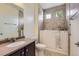Accessible bathroom with walk-in tub, safety bars, tiled walls, and modern vanity for safety and comfort at 5495 Espana Ct, Denver, CO 80249