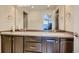Large bathroom vanity with dual sinks and dark wood cabinets at 5495 Espana Ct, Denver, CO 80249