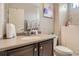 Well-lit bathroom with a granite counter top and tiled walls at 5495 Espana Ct, Denver, CO 80249