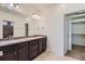 Double sink vanity and walk in closet provide ample storage in this well lit bathroom at 5495 Espana Ct, Denver, CO 80249