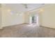 Large bedroom featuring plush carpeting, tray ceilings, and large sliding glass doors at 5495 Espana Ct, Denver, CO 80249