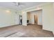 Large carpeted bedroom with natural light, ceiling fan, and ensuite bathroom at 5495 Espana Ct, Denver, CO 80249
