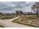 Well-maintained community dog park with secure fencing and arbor entrance at 5495 Espana Ct, Denver, CO 80249