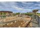 Well-maintained community garden with raised garden beds, gravel walkways, and wooden trellises at 5495 Espana Ct, Denver, CO 80249