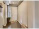 Welcoming entryway featuring hardwood floors, white door, and natural light from window at 5495 Espana Ct, Denver, CO 80249