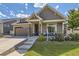 Charming home with a well-manicured lawn and landscaping, plus a welcoming front porch area at 5495 Espana Ct, Denver, CO 80249