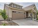 A two-car garage with a wide driveway and a covered front porch enhance the curb appeal of this home at 5495 Espana Ct, Denver, CO 80249