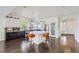 An open kitchen featuring a center island, stainless appliances, and contrasting white and dark cabinetry at 5495 Espana Ct, Denver, CO 80249