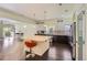 A modern kitchen offers a large center island with seating, stainless appliances, and hardwood floors at 5495 Espana Ct, Denver, CO 80249