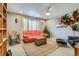 Comfortable living room with gray walls, orange sofa and ceiling fan at 5495 Espana Ct, Denver, CO 80249