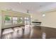 Sun-drenched living room boasts hardwood floors, a tray ceiling, recessed lights, and large windows with backyard views at 5495 Espana Ct, Denver, CO 80249
