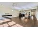 Expansive living space features hardwood floors, an open floor plan, and seamless flow into the adjacent kitchen at 5495 Espana Ct, Denver, CO 80249