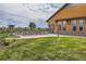 Inviting community pool area with lounge chairs, landscaped greenery, and a clubhouse, ideal for relaxation and recreation at 5495 Espana Ct, Denver, CO 80249