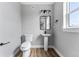 Half bathroom with a pedestal sink and a toilet at 1524 Ingalls St, Lakewood, CO 80214