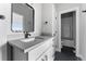 Bathroom vanity with drawers, a mirror, and access to a tiled shower at 1524 Ingalls St, Lakewood, CO 80214