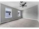 Carpeted bedroom with two windows, a ceiling fan, and neutral paint at 1524 Ingalls St, Lakewood, CO 80214