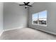 Bright bedroom with a large window, plush carpet, and a modern ceiling fan at 1524 Ingalls St, Lakewood, CO 80214