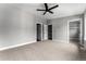 Spacious bedroom with plush carpet and a modern ceiling fan at 1524 Ingalls St, Lakewood, CO 80214