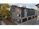 New townhome showing multi-level gray exterior with stone accents, a private garage, and contemporary design at 1524 Ingalls St, Lakewood, CO 80214