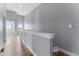 Second floor hallway with laminate flooring and a view of the neighborhood at 1524 Ingalls St, Lakewood, CO 80214