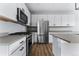 The kitchen includes stainless steel appliances, gray countertops, and ample storage at 1524 Ingalls St, Lakewood, CO 80214