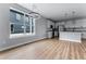 Open living area featuring a large window and a modern kitchen with stainless steel appliances at 1524 Ingalls St, Lakewood, CO 80214