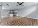 Sunlit living room featuring new flooring, a ceiling fan, and an open layout to the modern kitchen at 1524 Ingalls St, Lakewood, CO 80214