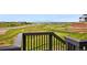 Scenic backyard view from a wooden balcony overlooking a green landscape with a road and neighborhood in the distance at 9382 Quaker St, Arvada, CO 80007