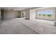 Unfinished basement with concrete floors, a sliding glass door, and three large windows, offering a blank canvas at 9382 Quaker St, Arvada, CO 80007