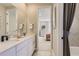 Bathroom view into bedroom featuring dual sinks and modern design at 9382 Quaker St, Arvada, CO 80007