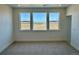 A bedroom with neutral carpet and three large windows offering lots of natural light and beautiful views at 9382 Quaker St, Arvada, CO 80007