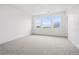 Large bedroom featuring neutral carpet, modern windows, and great natural light at 9382 Quaker St, Arvada, CO 80007
