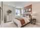 Bedroom showcasing decorative headboard with stylish accents and natural light at 9382 Quaker St, Arvada, CO 80007
