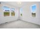 Bright bedroom filled with natural light from multiple windows and neutral carpet at 9382 Quaker St, Arvada, CO 80007