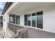 Spacious deck featuring sleek gray wood floors and sliding glass doors, with views of the surrounding community at 9382 Quaker St, Arvada, CO 80007