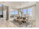 Inviting dining room with large windows, mountain view, and stylish furnishings at 9382 Quaker St, Arvada, CO 80007
