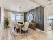 Chic dining room features modern lighting, textured accent wall, and mountain views at 9382 Quaker St, Arvada, CO 80007