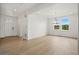 Inviting dining room with hardwood floors, a modern chandelier, and large windows providing ample natural light and view at 9382 Quaker St, Arvada, CO 80007