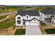 Charming two-story home with a three car garage, set against a lush green backdrop at 9382 Quaker St, Arvada, CO 80007