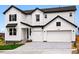 Charming two-story home with white siding, dark roof, and a two-car garage at 9382 Quaker St, Arvada, CO 80007