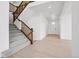 Inviting foyer with staircase, light wood floors, and bright natural light at 9382 Quaker St, Arvada, CO 80007